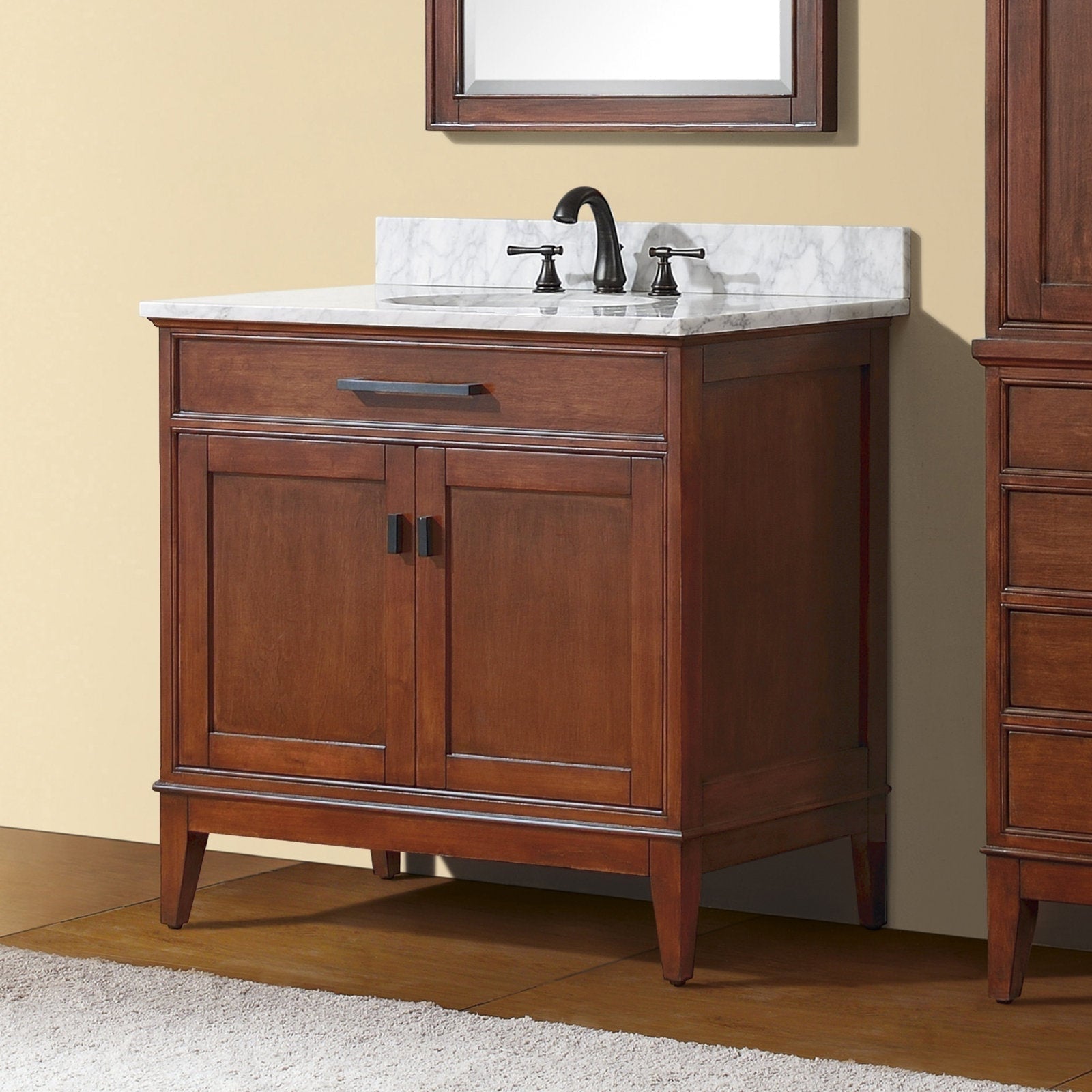 Freestanding modern solid wood bathroom vanity in warm tobacco brown with white stone marble top, single undermount sink and black two-handle faucet, featuring a single drawer and two-door cabinet for storage.