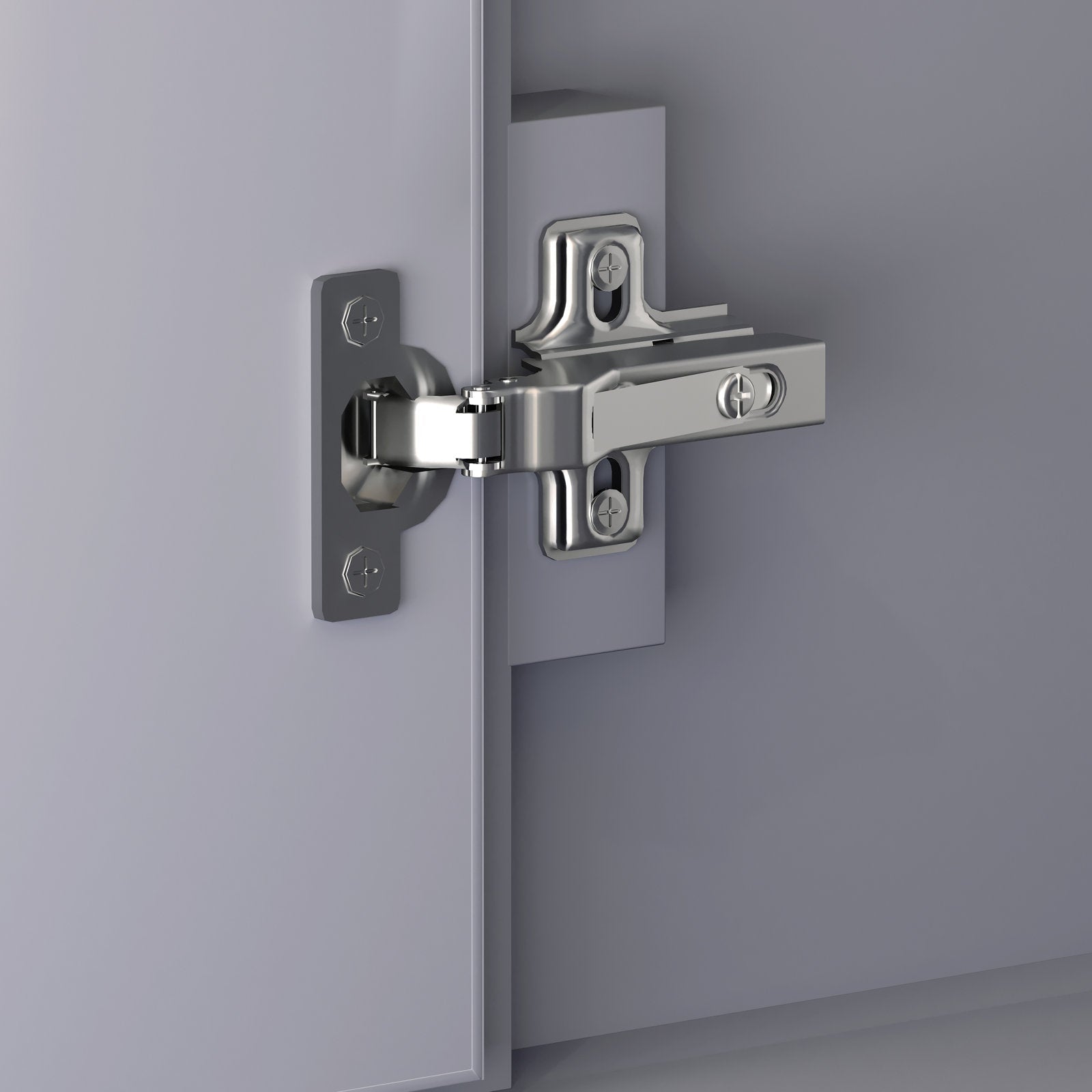 Close-up of a polished chrome European-style cabinet hinge mounted on a stone-colored solid wood vanity door and jamb, showing the screw plates and pivot mechanism.