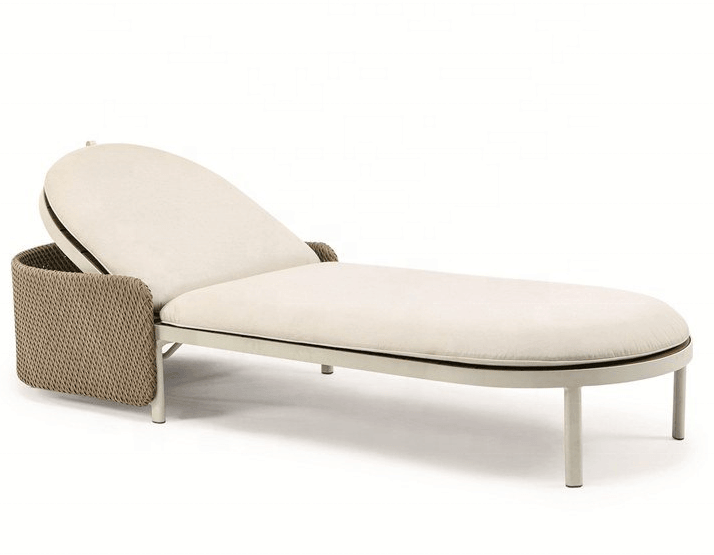 Curved coastal sun lounger with natural beige fabric cushions on a light metal frame and woven rope backrest, shown in a low reclined position.