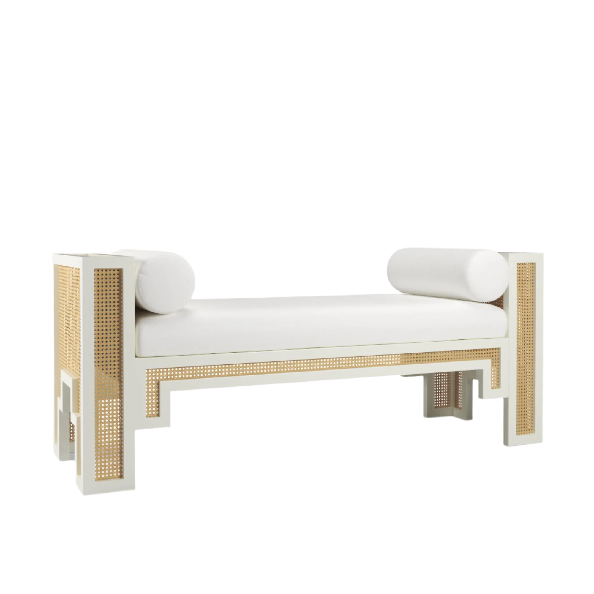 White upholstered end-of-bed bench with a solid wood frame and natural rattan cane panels, featuring a cushioned rectangular seat and two white cylindrical bolster pillows in a boho-contemporary style.