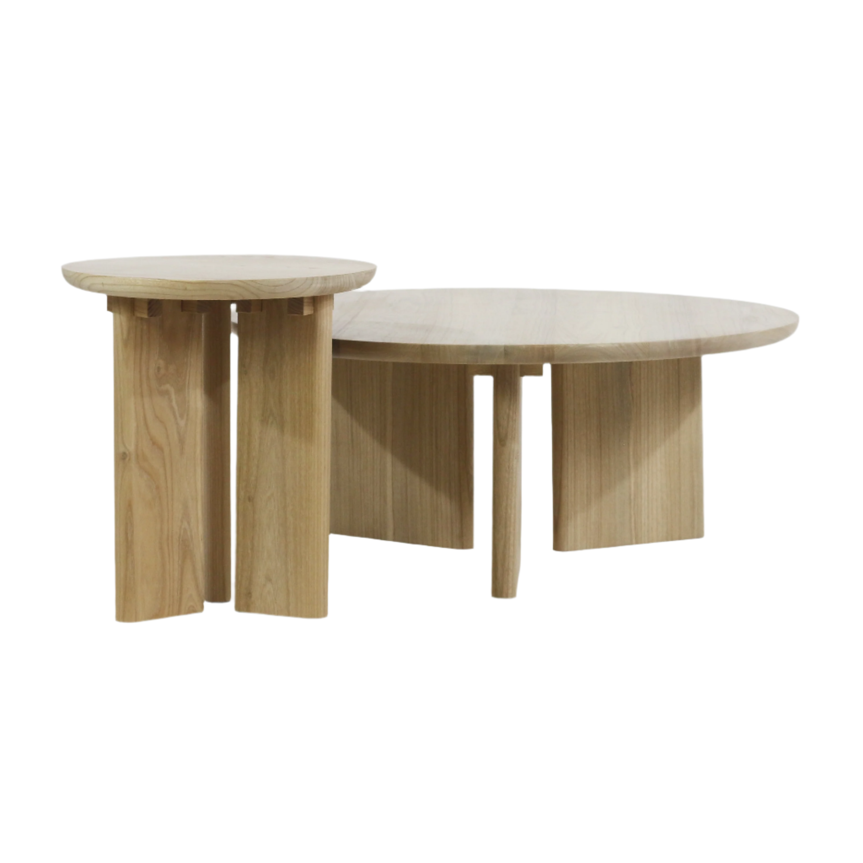 Pair of round solid oak coffee tables in a natural oak finish — a low, wide coffee table paired with a taller, narrower nesting table, both with smooth round tops and thick paneled legs in a modern minimalist style.