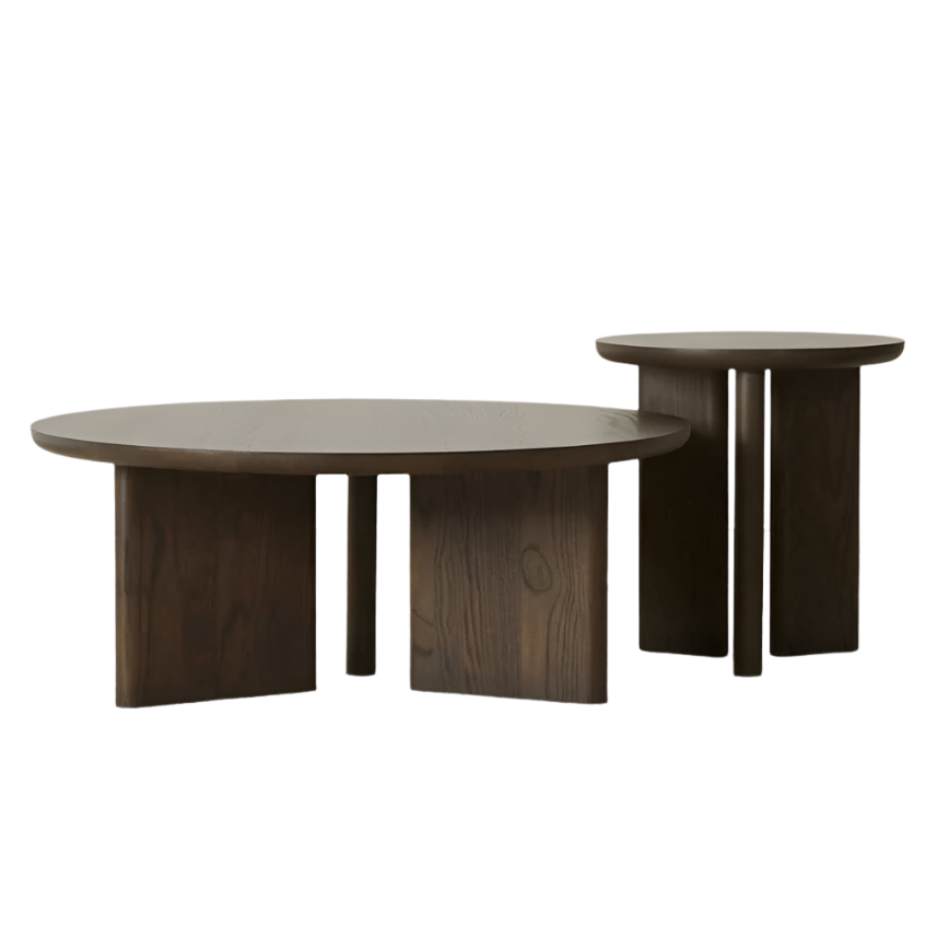 Pair of modern solid oak coffee tables in a dark walnut finish: one low round coffee table and one taller round side table, each with thick slab tops and sculptural slab-and-post legs showcasing natural oak grain.