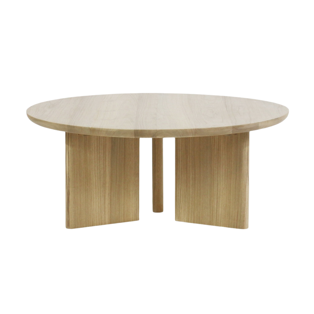Modern round solid oak coffee table with a thick circular top and three-panel pedestal base in a light natural oak finish, shown against a white background.