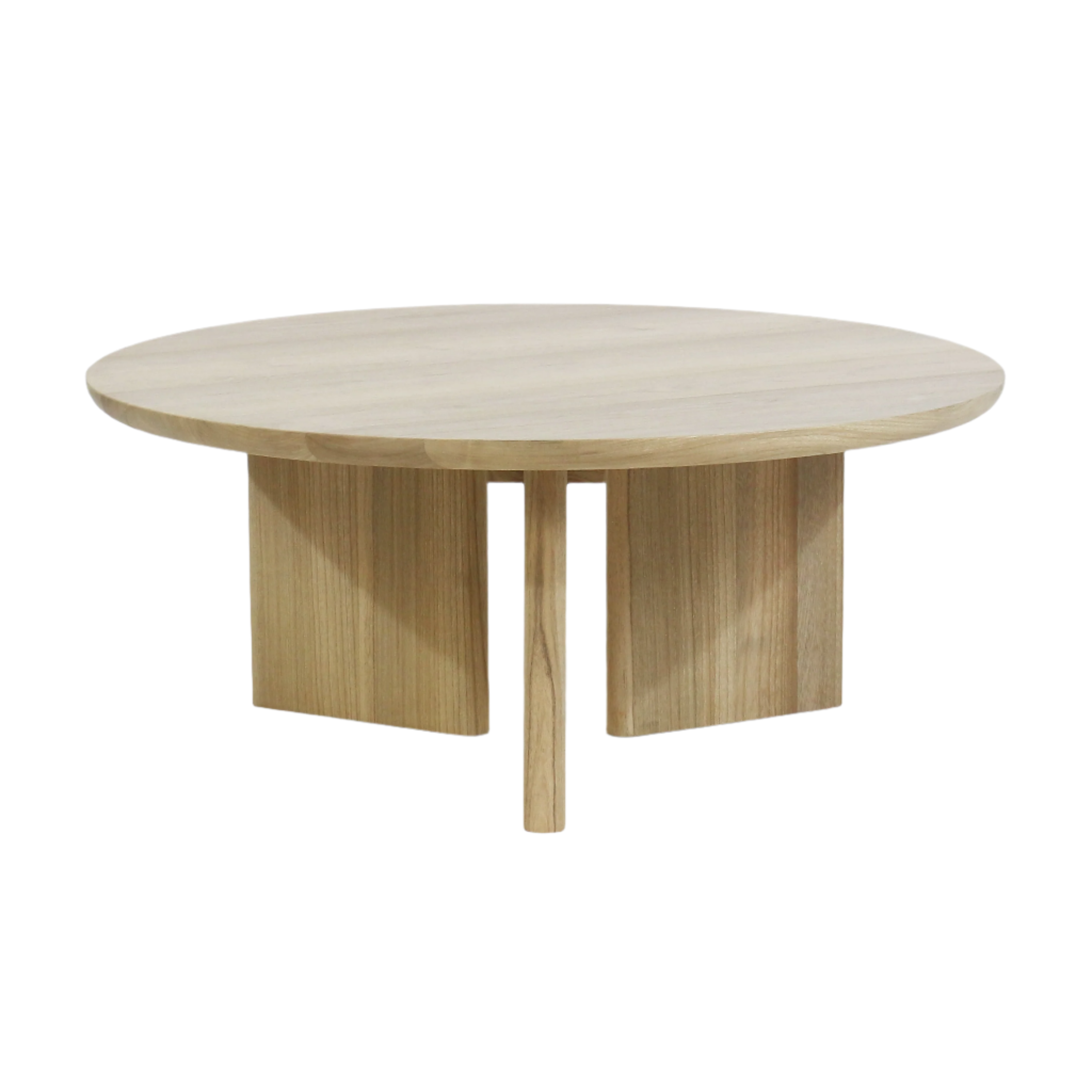 Round solid oak coffee table with a thick circular top and a three-part pedestal base composed of two wide curved panels and a central round leg, finished in light natural oak for a modern minimalist look.