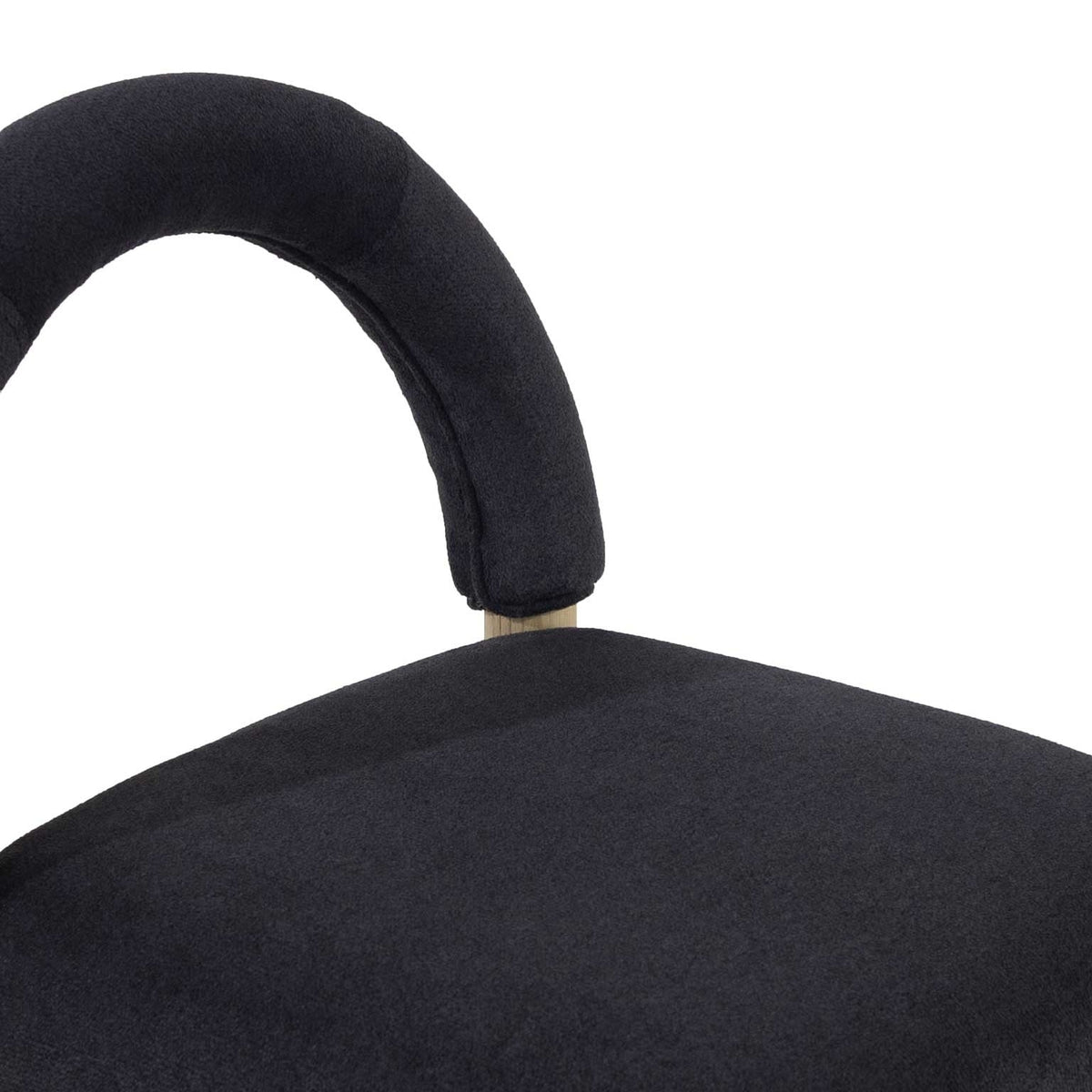 Close-up of a stool's curved low back and cushioned seat upholstered in charcoal bouclé fabric with a visible oak support post.
