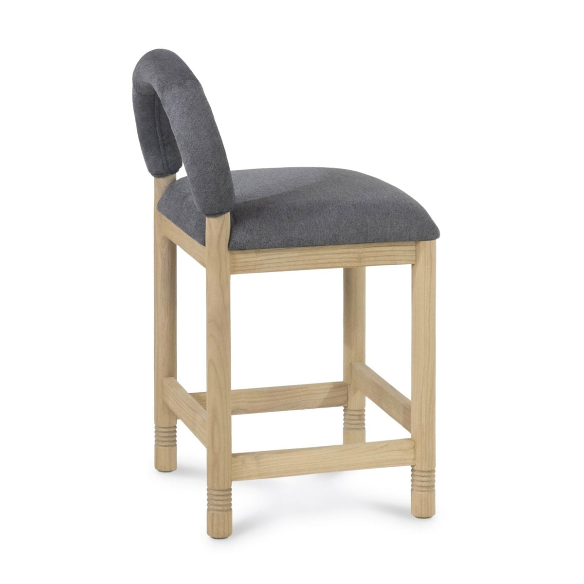 Side view of a counter-height stool with a natural oak frame and cushioned gray bouclé seat and low rounded backrest.