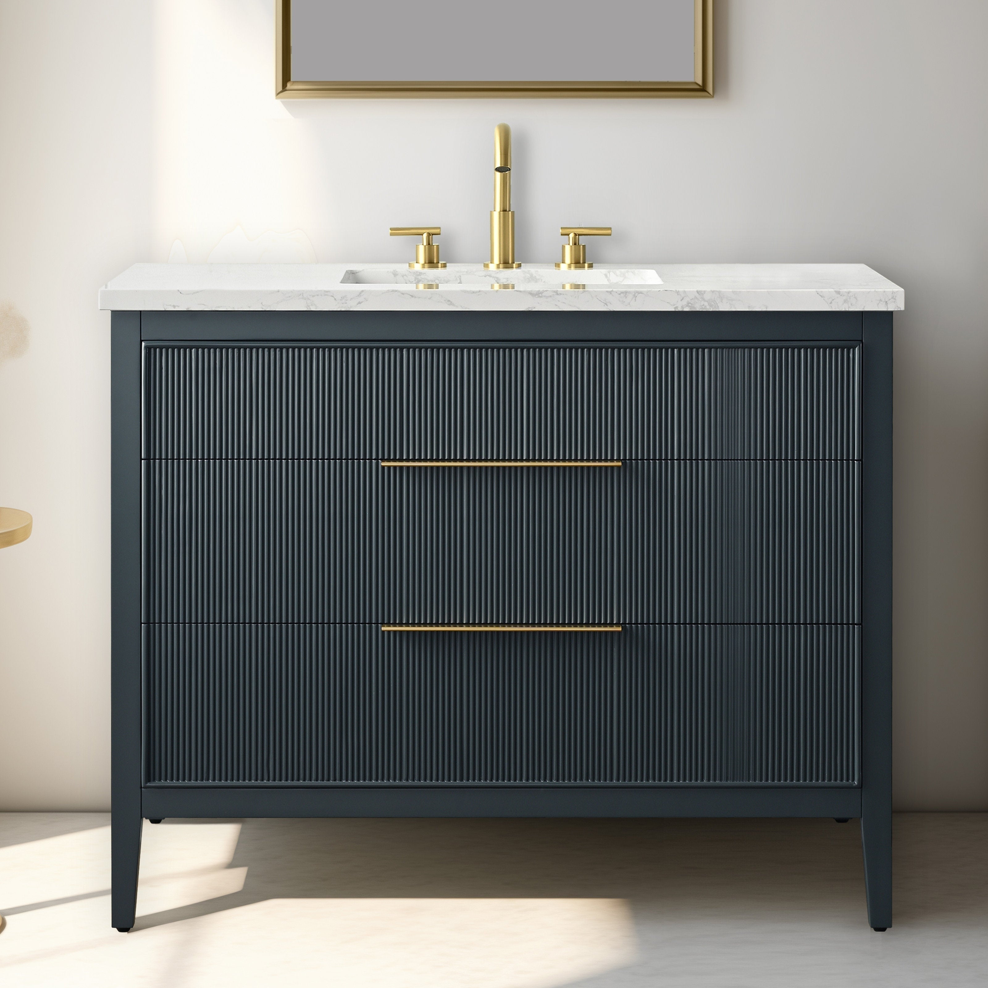 42-inch modern solid wood single-sink bathroom vanity with white stone top, integrated rectangular sink, fluted dark drawer fronts, and brass faucet with slim brass drawer pulls.