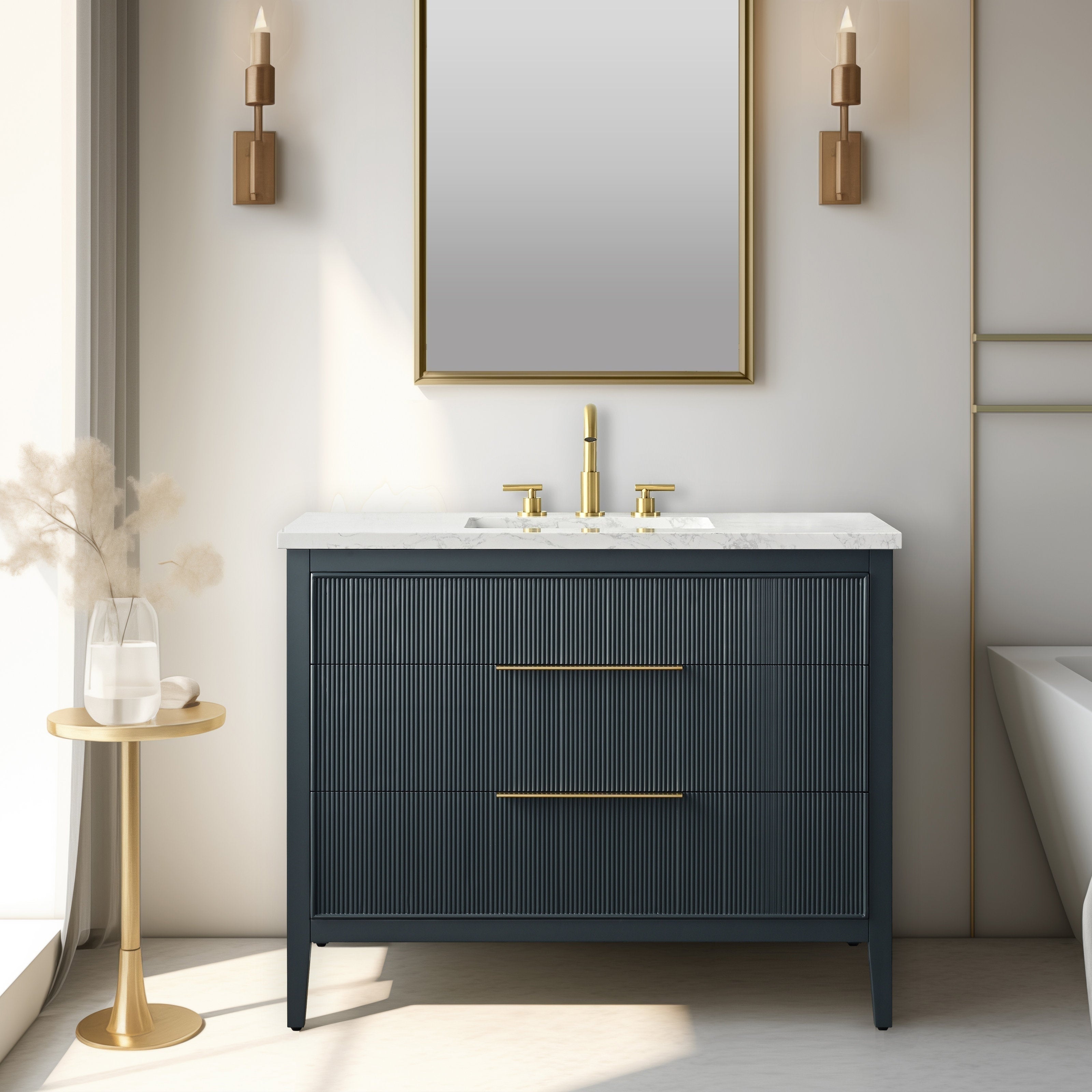 Modern solid wood single-sink bathroom vanity with a white stone top and integrated ceramic sink, dark fluted drawer fronts, brass faucet and long brass handles, freestanding tapered legs, gold-framed mirror and wall sconces.