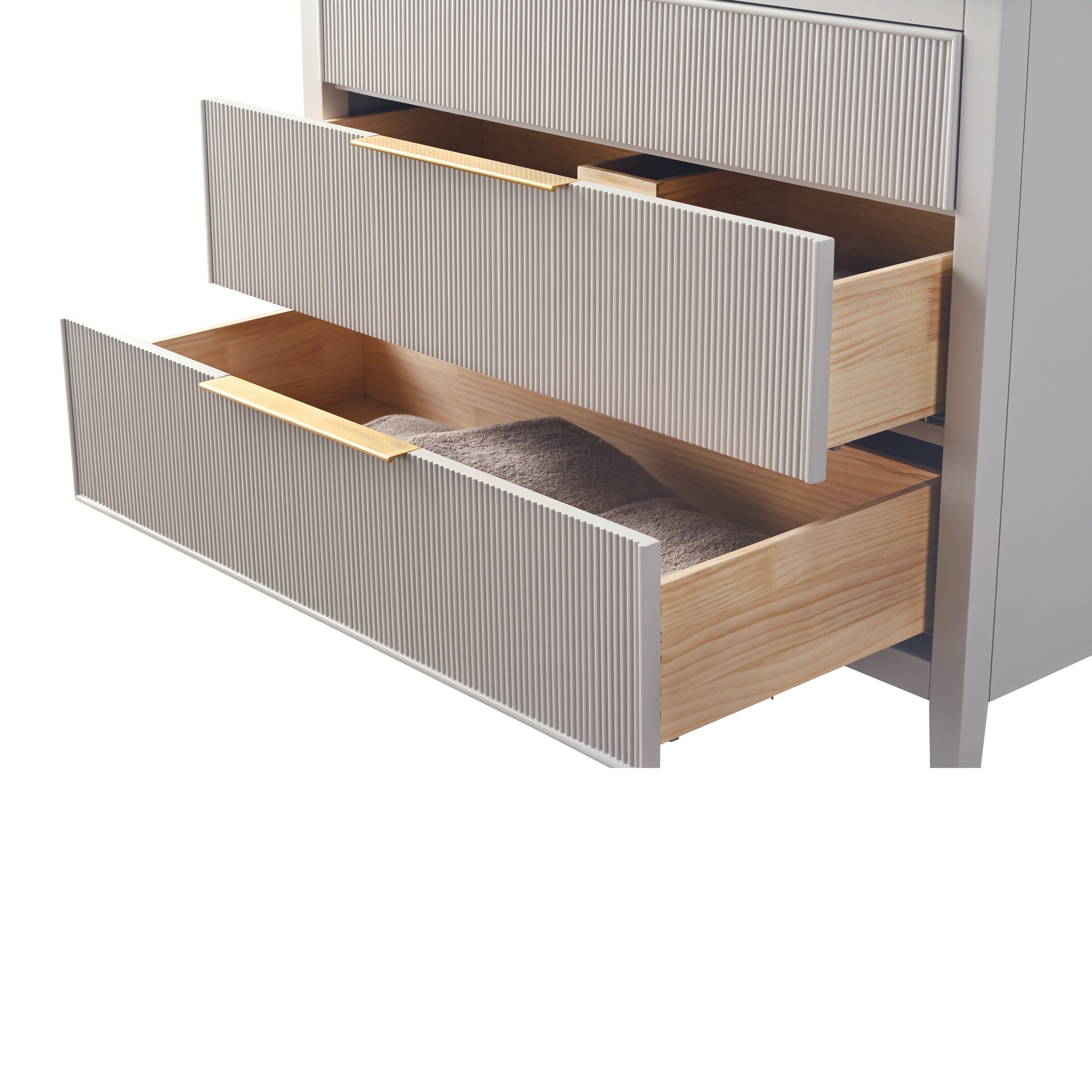 Close-up of a modern stone-colored bathroom vanity showing two open ribbed drawer fronts with solid wood interiors and gold-tone pulls; the lower drawer holds a folded taupe towel.