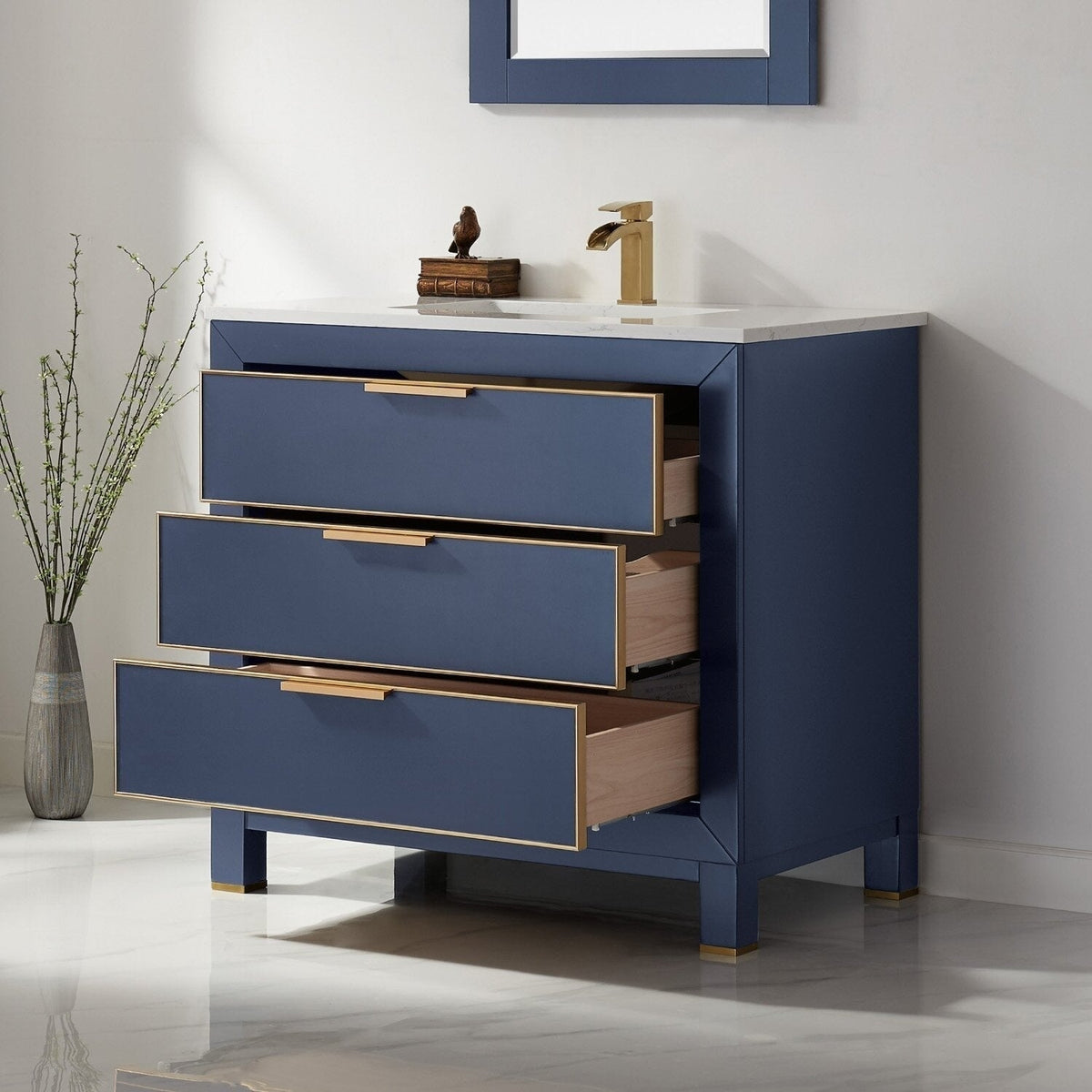 Freestanding modern 36-inch solid wood bathroom vanity with a white stone top and deep blue painted case; three soft-close drawers with gold trim and matching gold faucet, drawers partially open to show wood interiors.