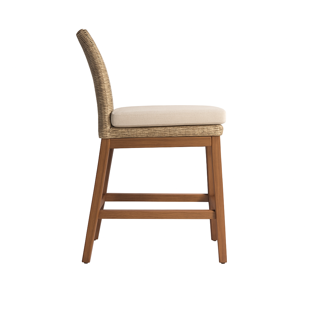 Side view of an armless outdoor bar stool with teak wood legs, woven natural-fiber back and a cushioned beige fabric seat in a coastal style.