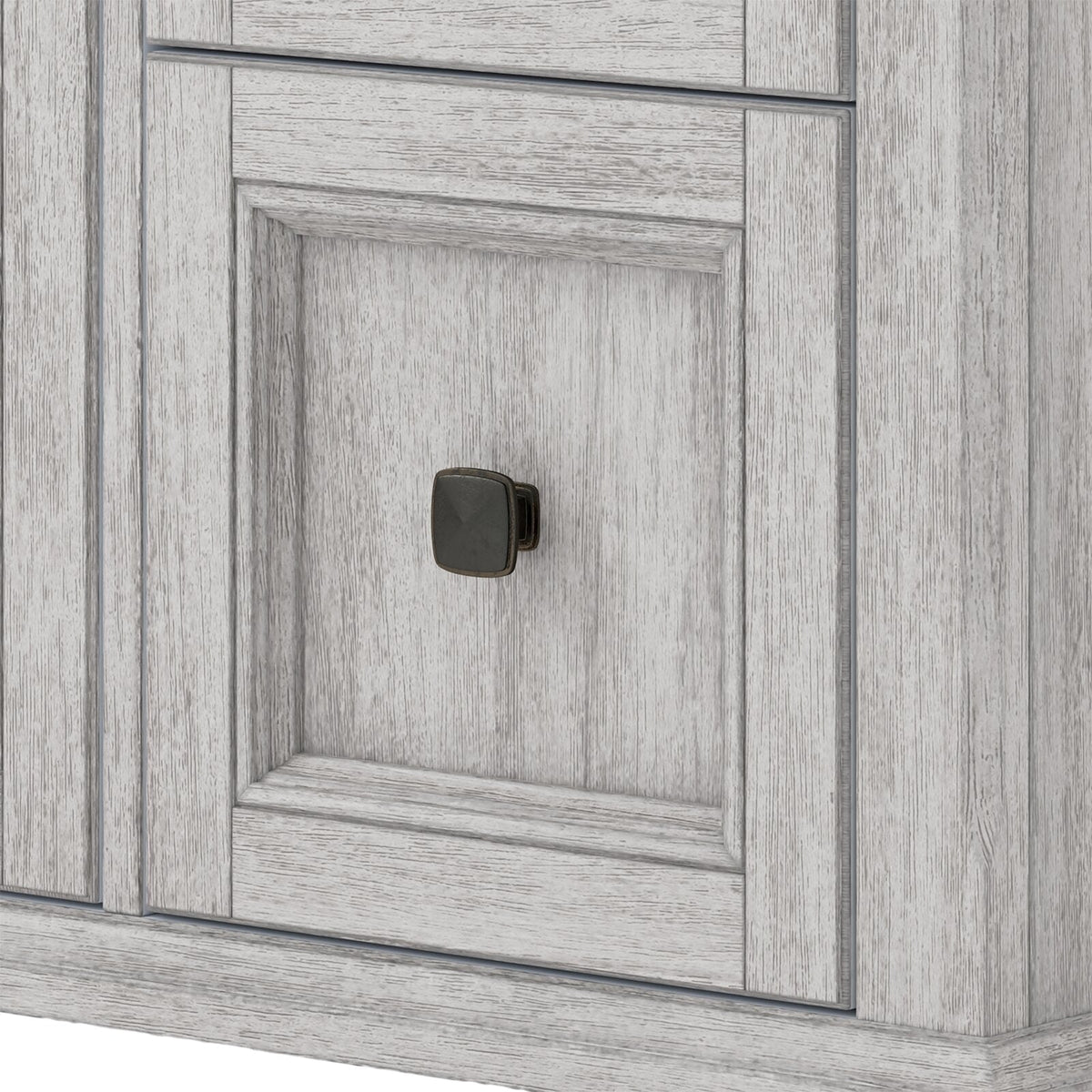 Close-up of a stone gray solid wood bathroom vanity door with recessed paneling and a dark square metal knob, highlighting the wood grain texture and contemporary distressed finish.