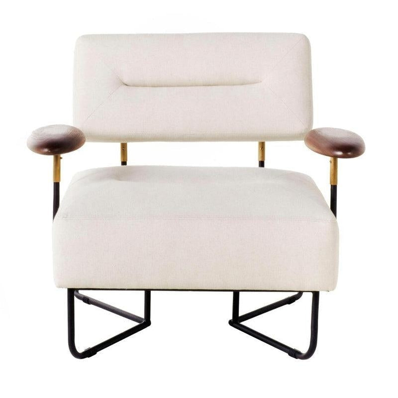 Off-white fabric upholstered low lounge chair with a rectangular padded back and wide cushioned seat, brown wooden arm pads on brass-accented metal supports, and a black metal sled-style base.