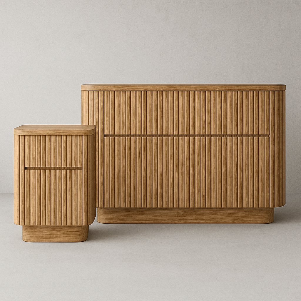 Natural oak fluted dresser and matching nightstand with rounded corners and integrated drawer grooves, low modern silhouette on a continuous plinth base against a neutral studio backdrop.