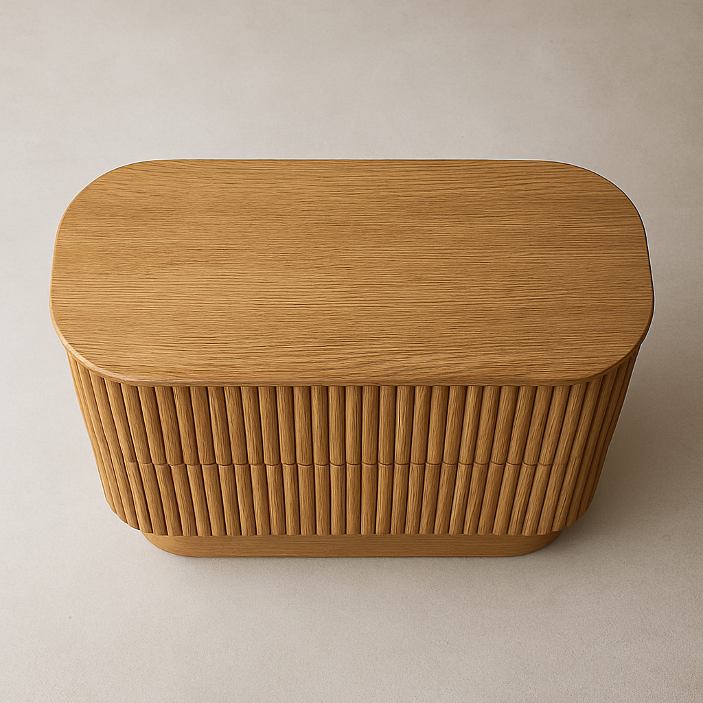 Top-down view of a natural oak dresser with a rounded rectangular top and vertically fluted drawer-front texture, showing smooth wood grain and a curved base on a neutral beige background.
