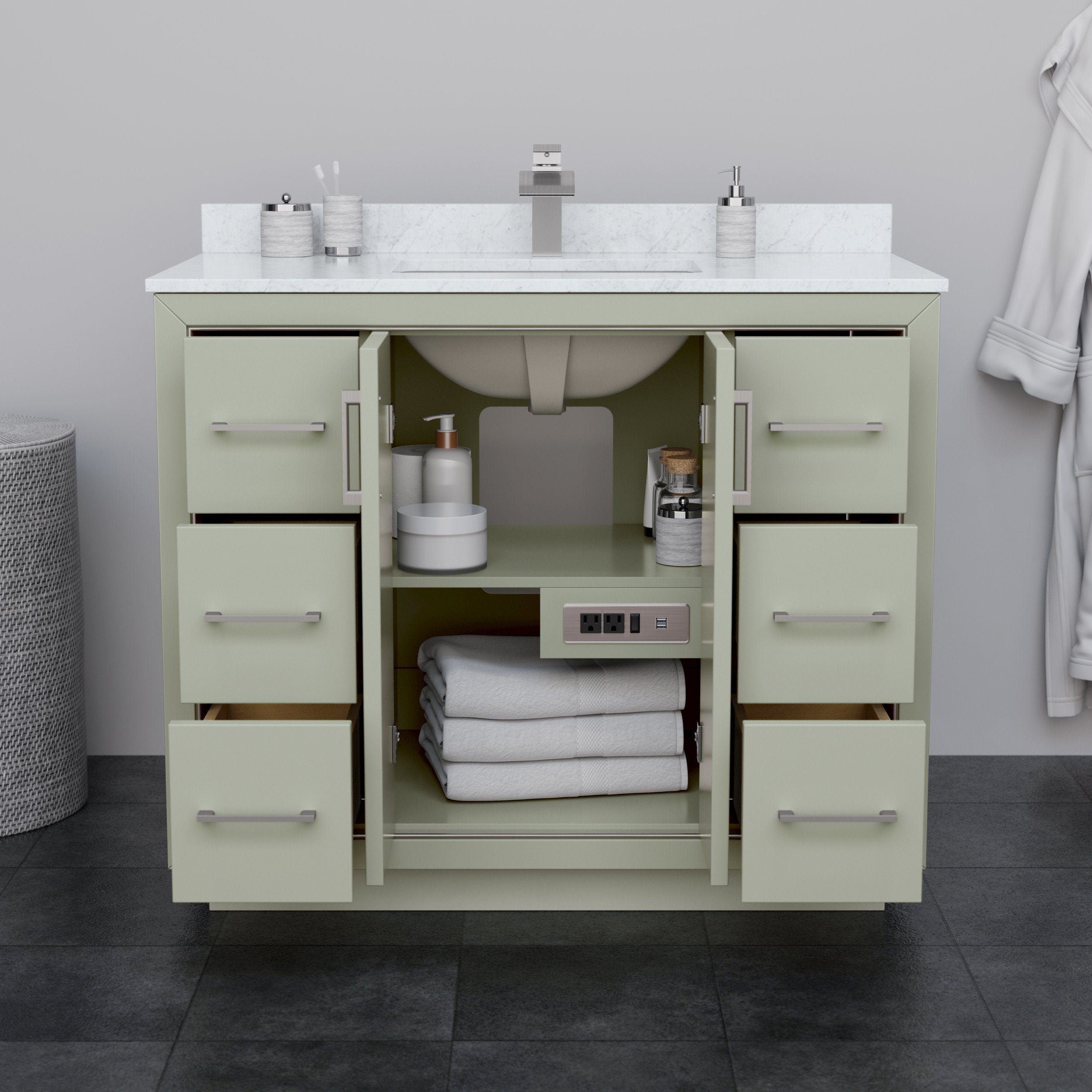 Modern solid wood bathroom vanity in a stone finish with a white stone countertop and single undermount sink, brushed-nickel faucet and handles; center doors open to show folded towels, toiletries and an integrated power outlet.