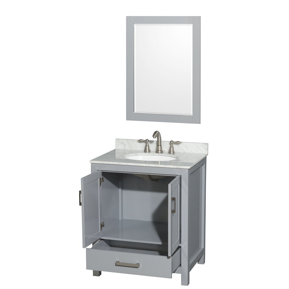 Modern gray solid-wood bathroom vanity with white stone countertop and integrated ceramic sink, matching framed mirror above, brushed nickel faucet, open cabinet doors and drawer revealing interior storage.