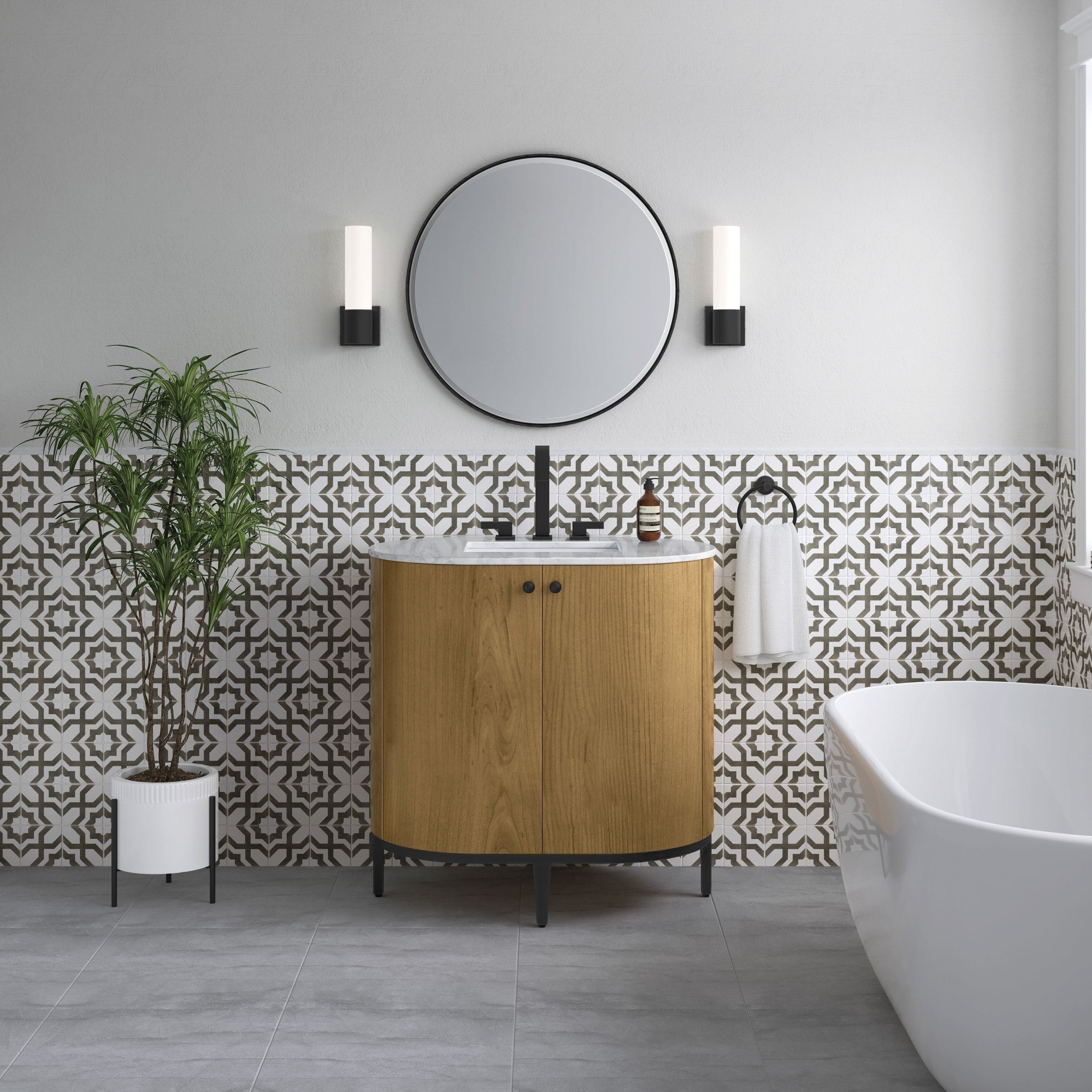 36-inch single-sink modern wood bathroom vanity with Carrara marble top, black metal legs and matte-black faucet, pictured with patterned tile half-wall, round mirror, wall sconces, potted plant and freestanding tub