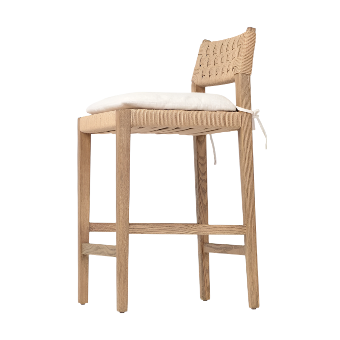 Natural oak counter stool with woven papercord back and seat, squared oak legs and cross stretchers, shown with a tied white seat cushion on a plain background.