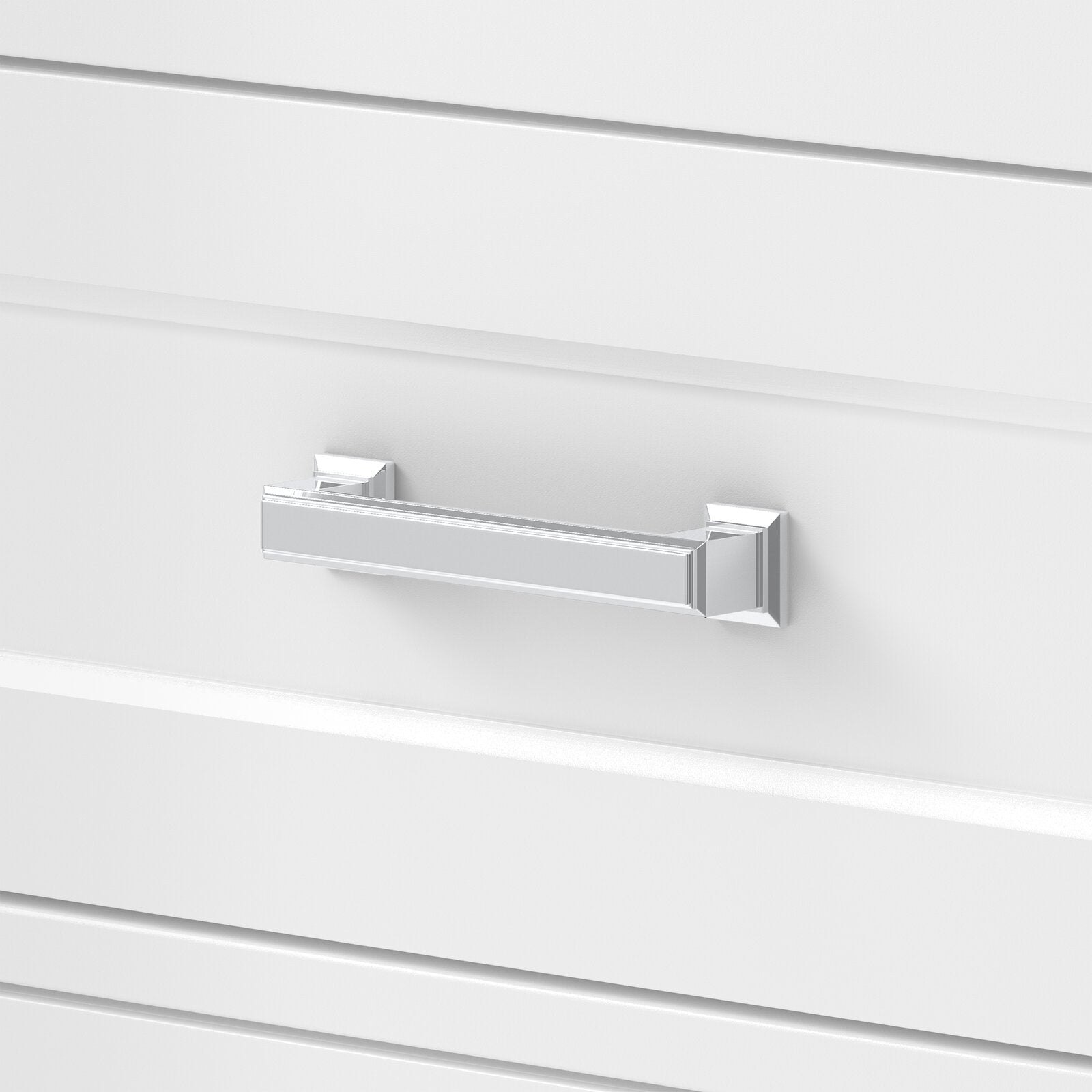 Close-up of a polished chrome rectangular drawer handle mounted on a stone-colored solid-wood modern bathroom vanity drawer front.