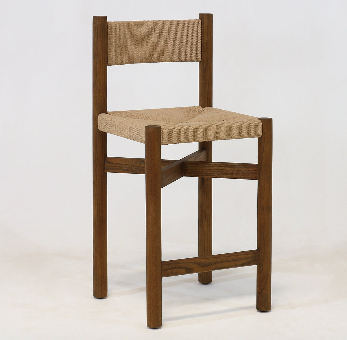 Armless walnut-finished oak counter stool with a natural papercord woven seat and low woven back, square legs and cross-stretcher footrest, photographed on a white studio background.