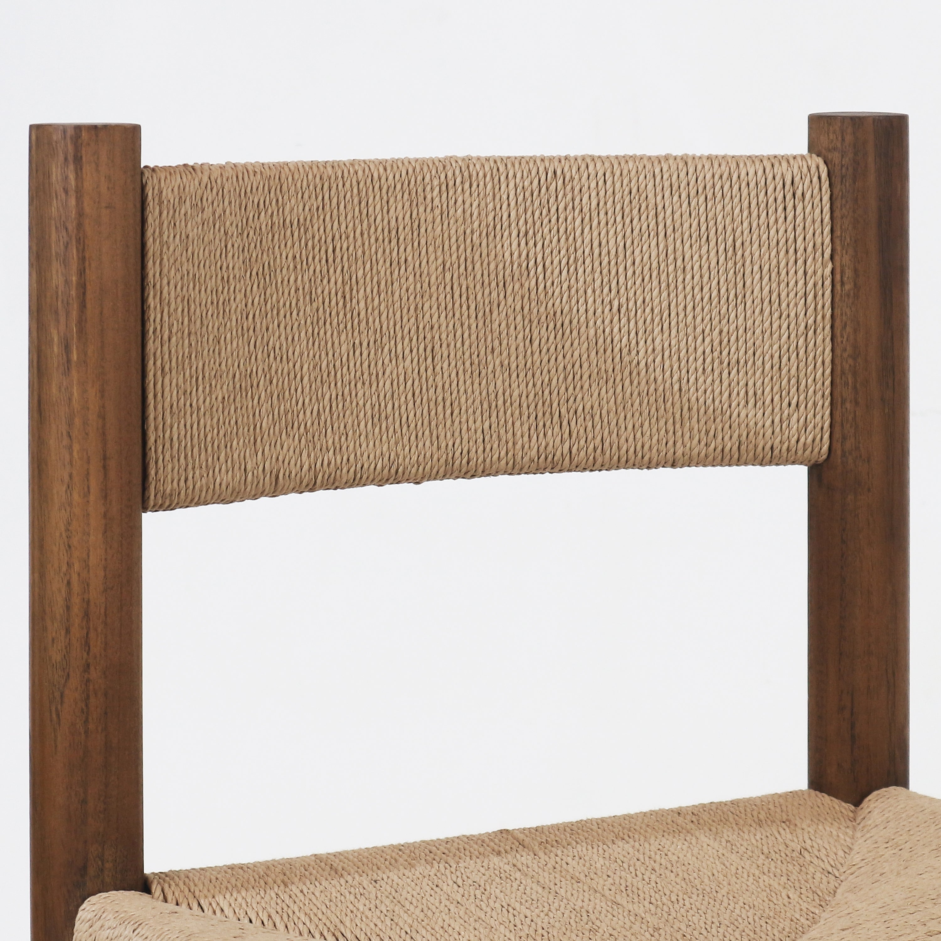 Close-up of a natural papercord woven back and seat attached to a walnut-stained solid wood frame with rounded vertical posts.