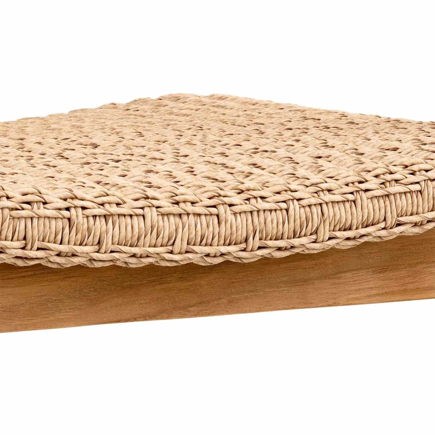 Close-up of a natural teak dining chair showing a tightly woven beige synthetic-fiber seat with braided edging above a smooth teak wood frame.