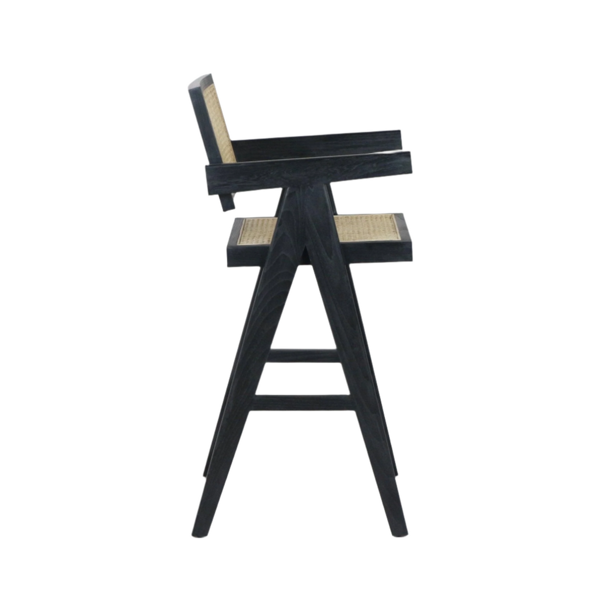 Side view of a black-stained wooden bar stool with woven natural rattan seat and back, A-frame tapered legs, integrated armrests and a footrest in a mid-century modern style.