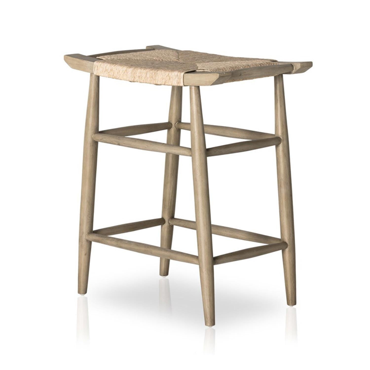 Backless outdoor bar stool in natural teak with a woven seat, tapered legs and integrated square footrest in a coastal Scandinavian style.