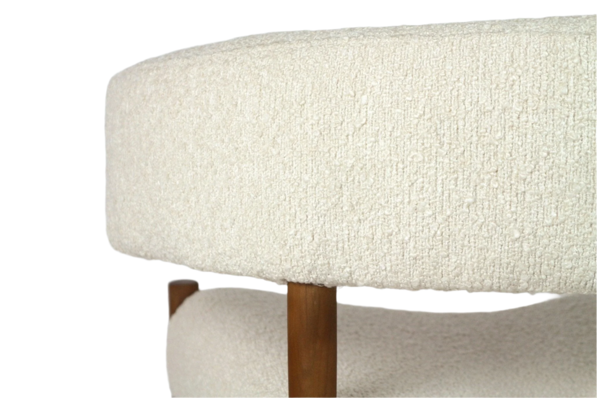 Close-up of a cream boucle upholstered chair showing textured curved seat and back with a visible natural wood leg.