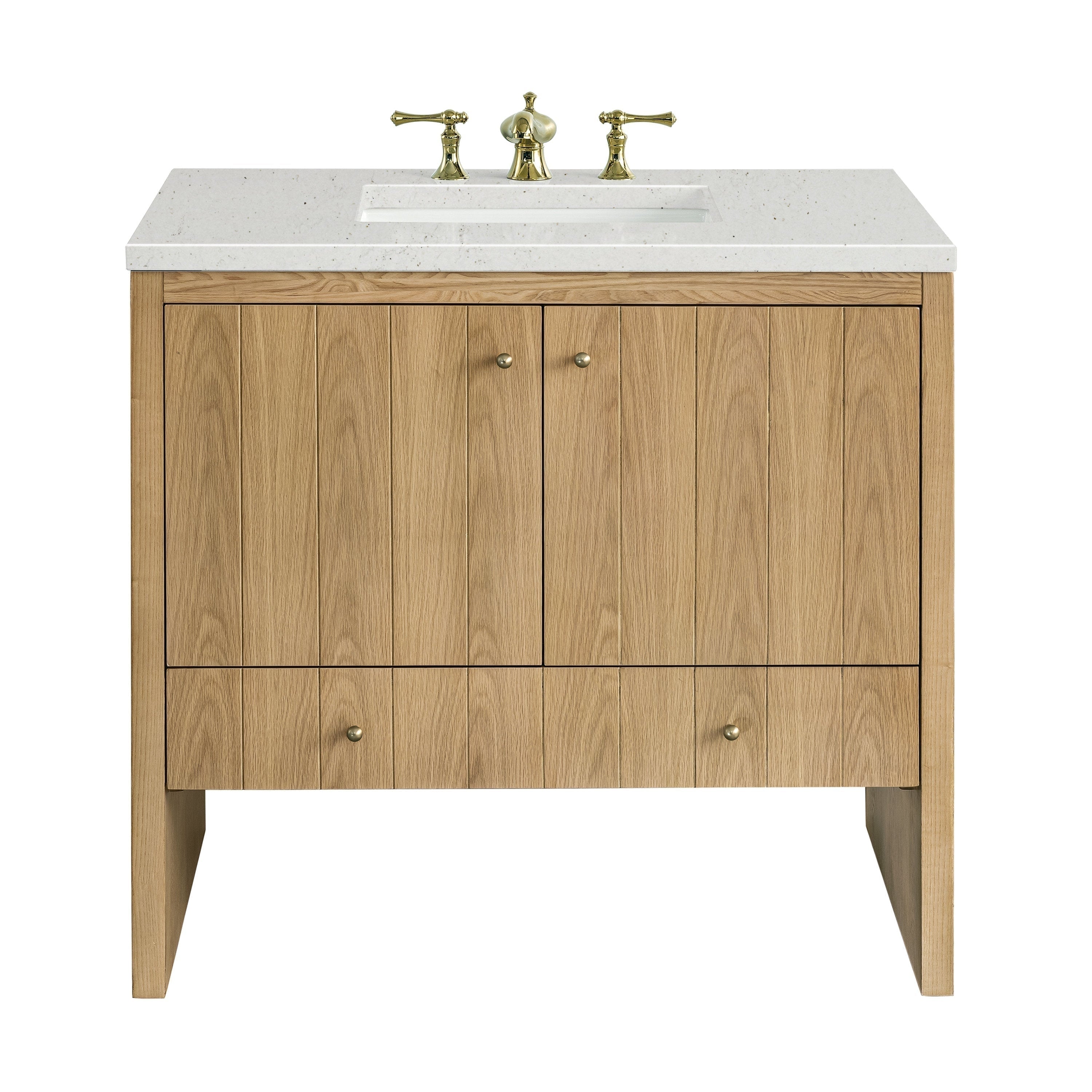 The NUEMA Sala 36 Single Bathroom Vanity features solid oak construction, vertical panels, two central cabinet doors, a lower drawer, a white stone countertop with inset sink, and gold faucet handles in a modern minimalist design.