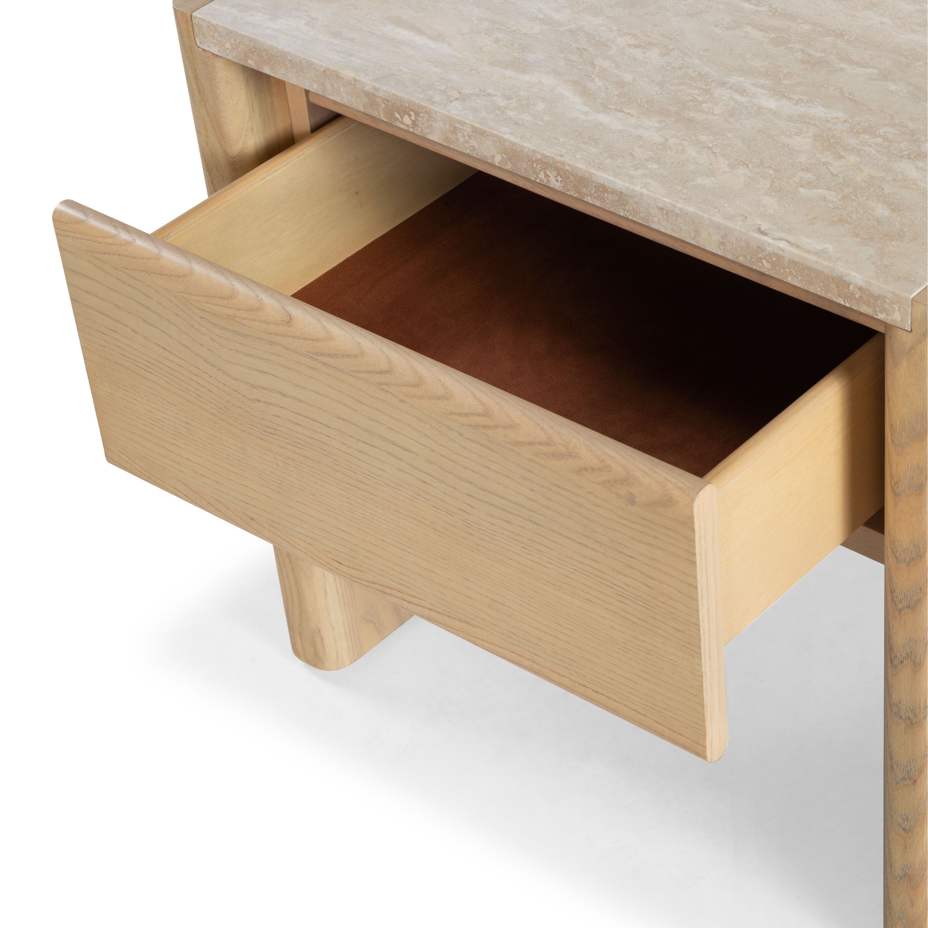 Close-up of a marble-top natural wood nightstand with a beige stone surface and an open drawer showing a brown felt-lined interior and smooth rounded drawer front in a minimalist modern style.