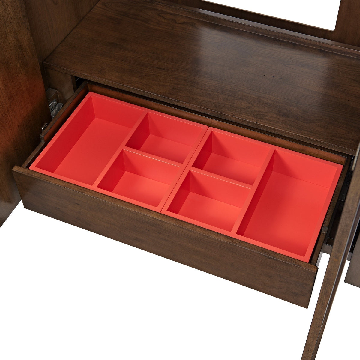 Open modern solid wood bathroom vanity drawer revealing a bright red partitioned organizer insert with multiple compartments and warm brown wood grain interior.
