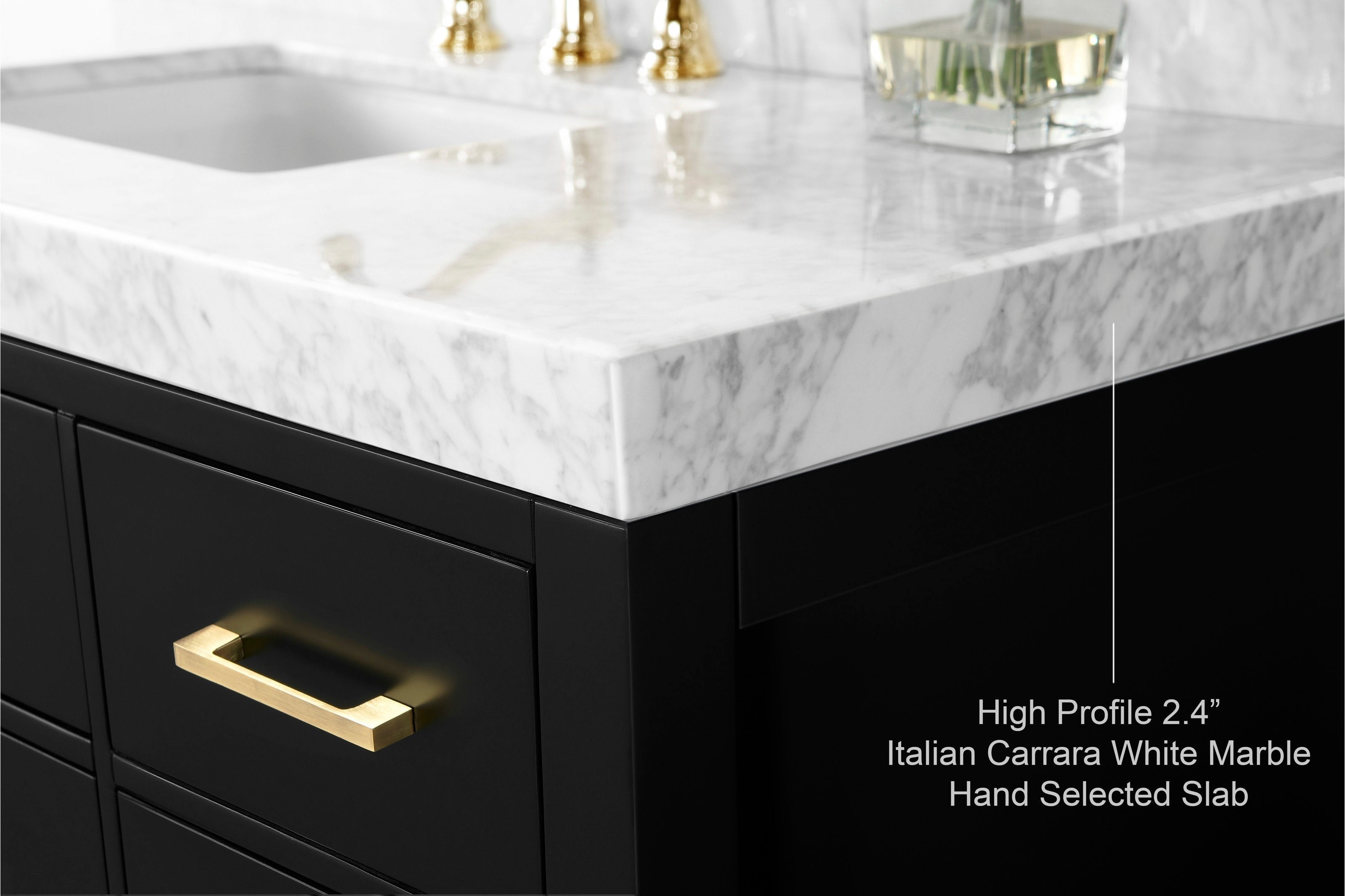 Close-up of a high-profile 2.4-inch Italian Carrara white marble countertop with undermount sink, set on a matte black solid wood vanity with a rectangular brass drawer pull and polished brass faucet reflection.