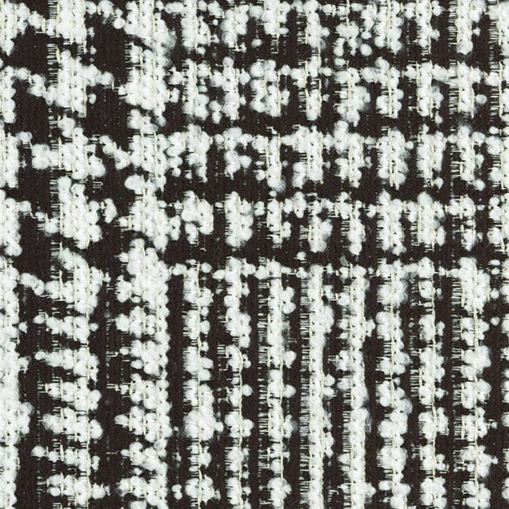 Close-up of black-and-white boucle upholstery fabric showing nubby woven texture, 29% viscose / 11% acrylic / 60% polyester composition, heavy-duty and suitable for contemporary sofa upholstery.