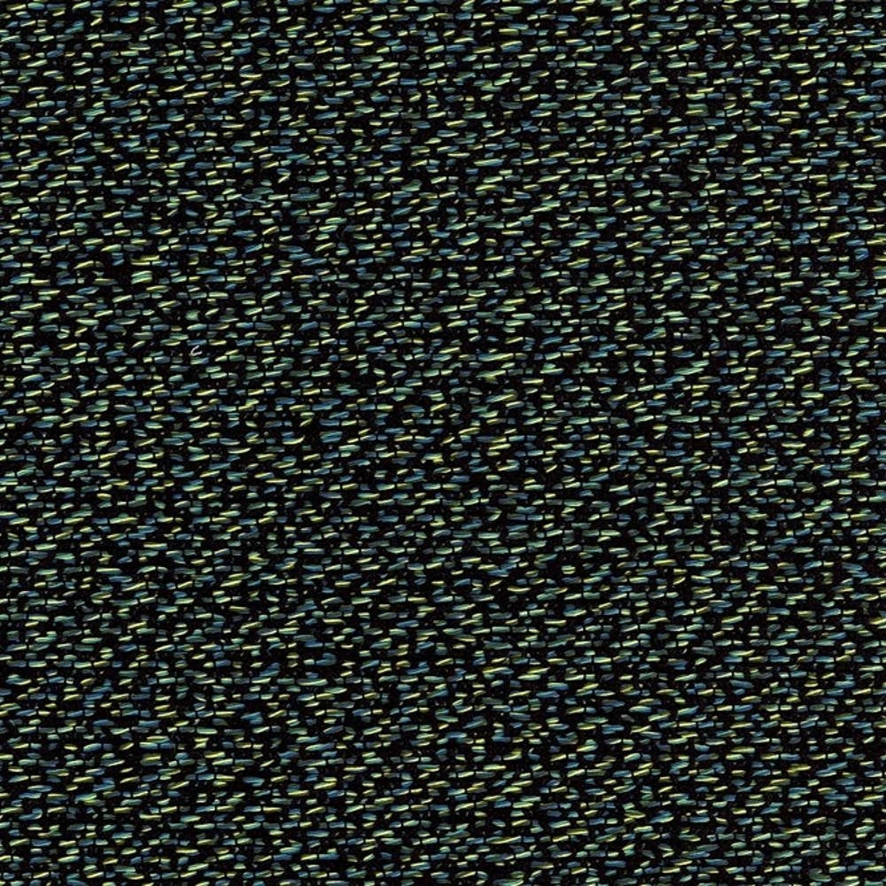 Close-up of contemporary rayon and polyester upholstery fabric showing a dark neutral background with densely woven small green and blue flecks, textured for sofa use.