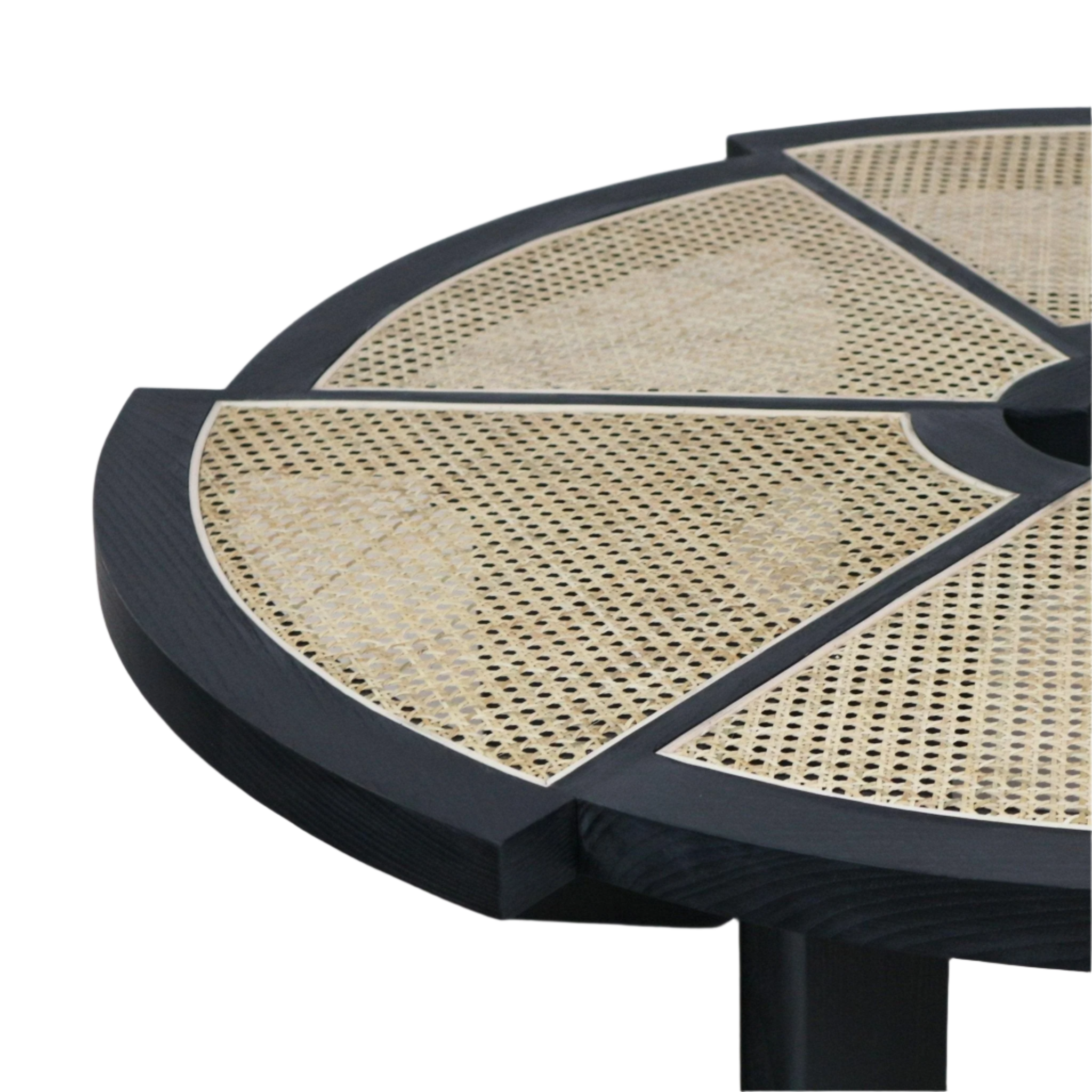 Close-up of a round modern coffee table top showing a black stained wood frame with natural woven cane panels arranged in segmented radial sections and a portion of the black pedestal leg.