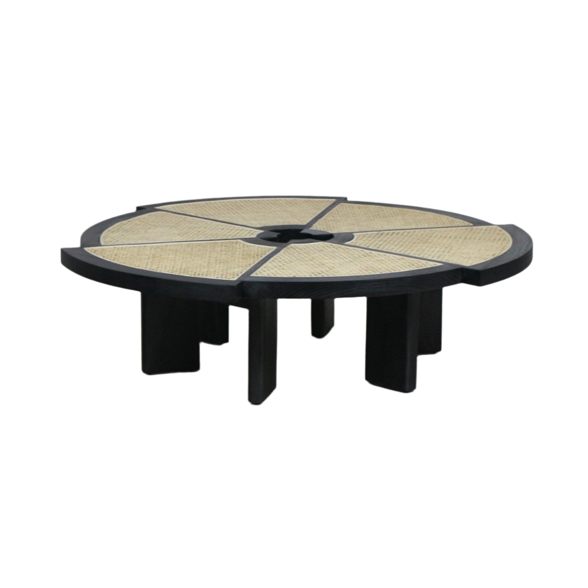 Low round coffee table with a black wooden frame and six natural cane inlaid wedge panels radiating from a small central opening, supported by chunky black block legs in a modern midcentury style.