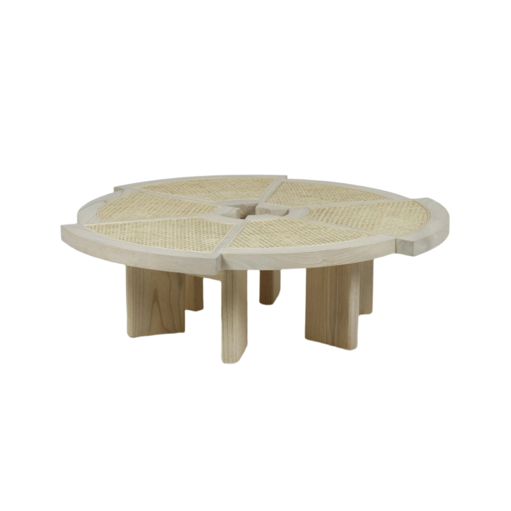 Low round coffee table in natural wood with woven cane inset panels arranged in six pie-shaped sections, thick notched legs and a shallow recessed center for a modern, minimalist living room look.